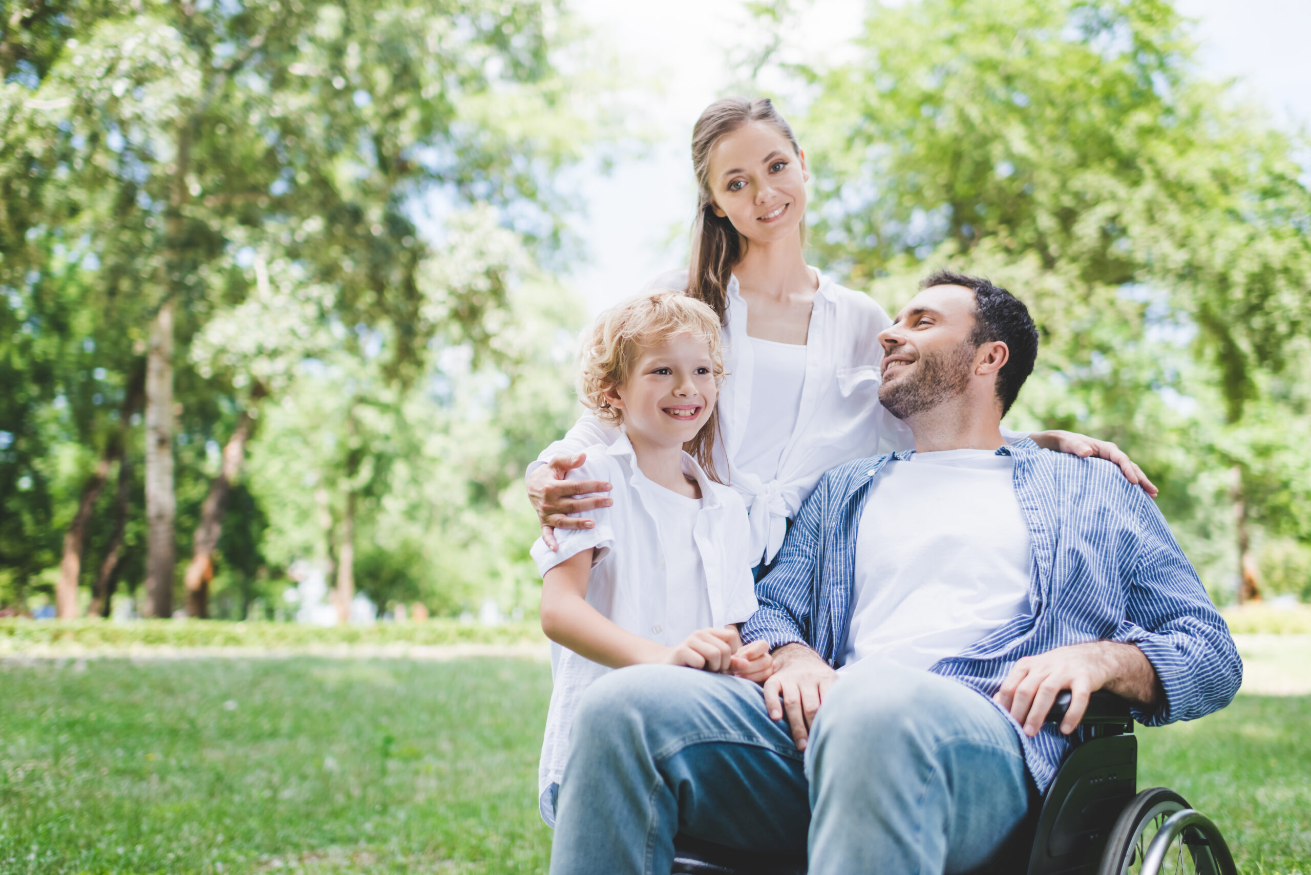 Family caregiver walking alongside elderly father using a walker